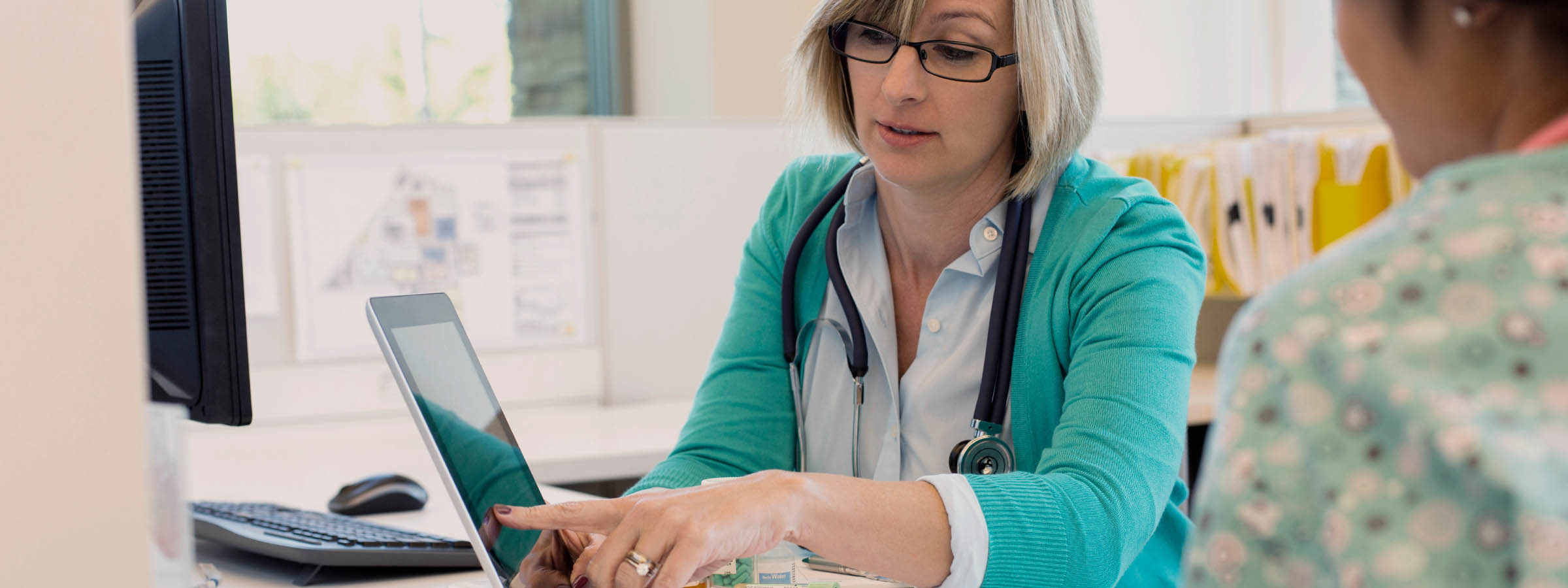 Registered nurse explaining charting preparation to fellow nurse