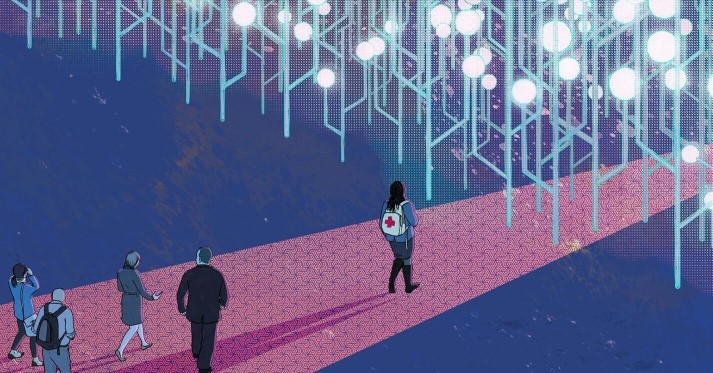 Image of people walking on pink carpet illuminated by shining overhead lights