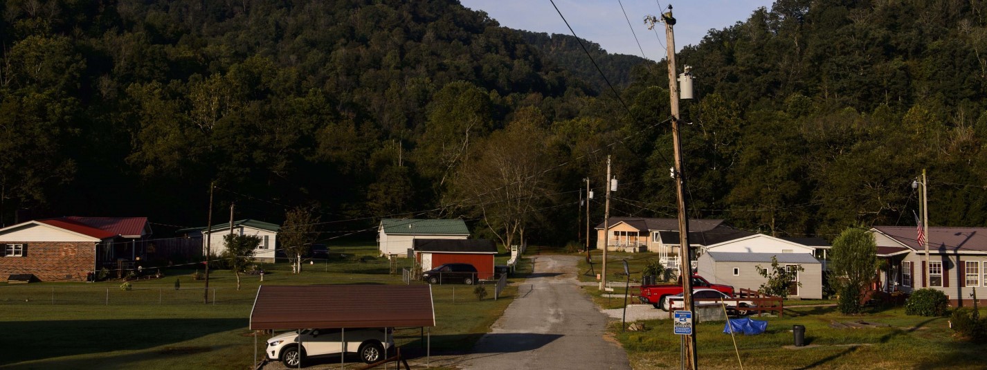 Homes with hills behind them in rural West Virginia.
