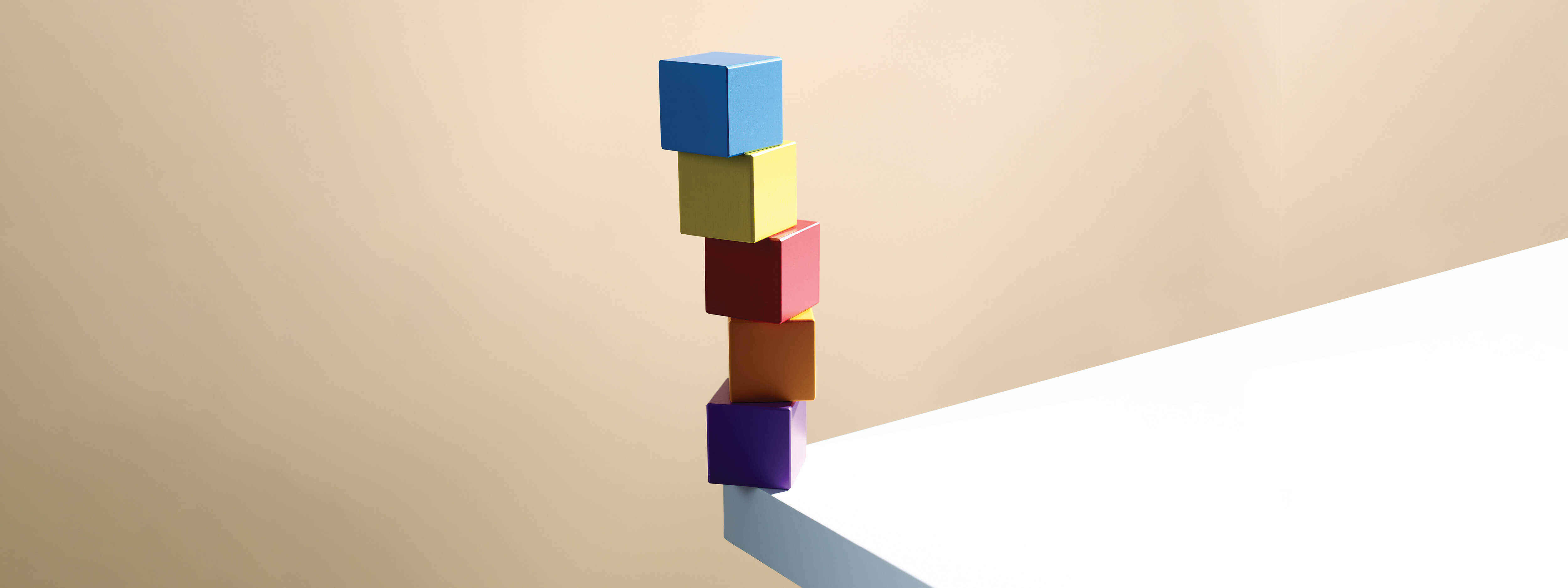 Colorful blocks stacked on the edge of a white countertop