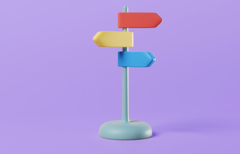 Red, yellow, and blue directional post set in a soft purple background