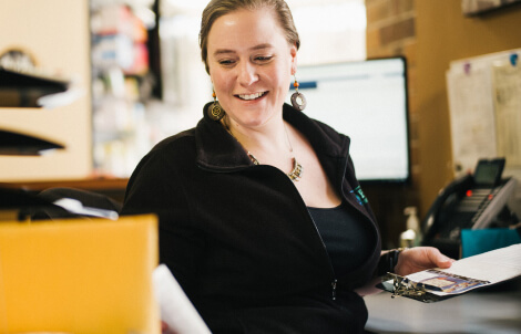 A member of a clinical staff smiles, while using a successful value-based care system.