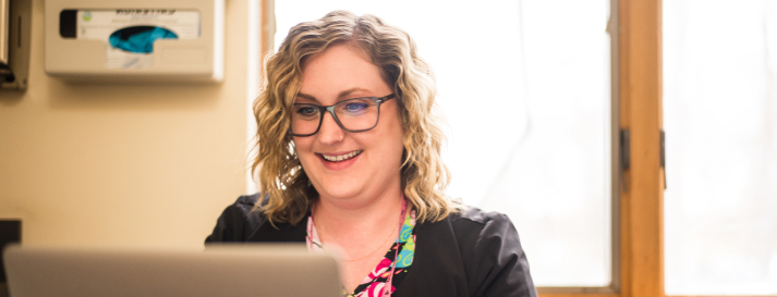 A woman smiles, showing how medical billing software improves healthcare practice operation.