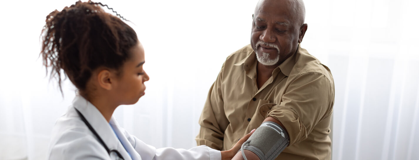 Physician taking blood pressure of medicare patient