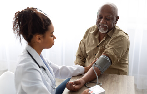 Physician taking blood pressure of medicare patient