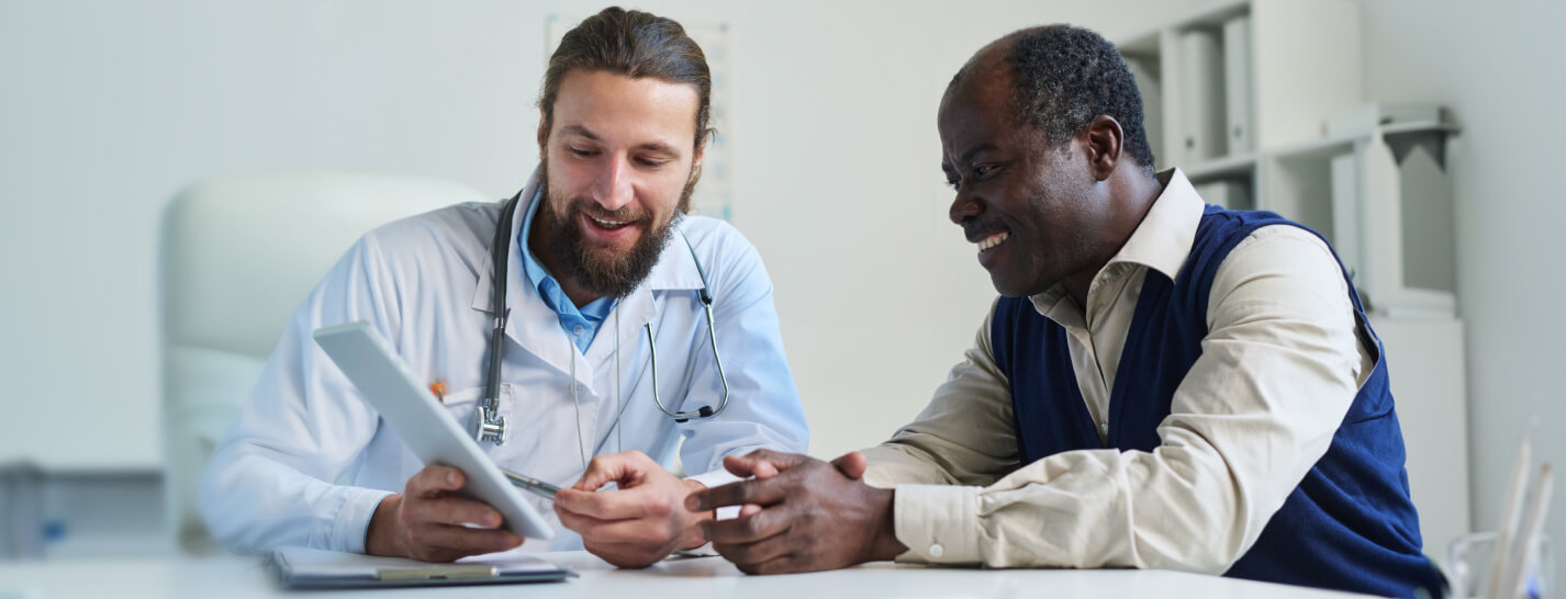 male physician reviewing health record with medicare patient