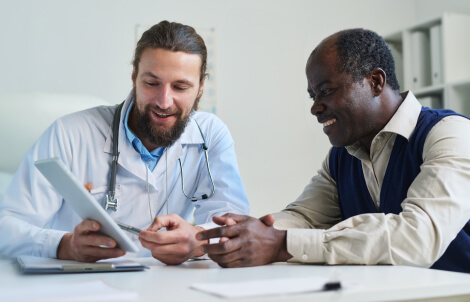 male physician reviewing health record with medicare patient