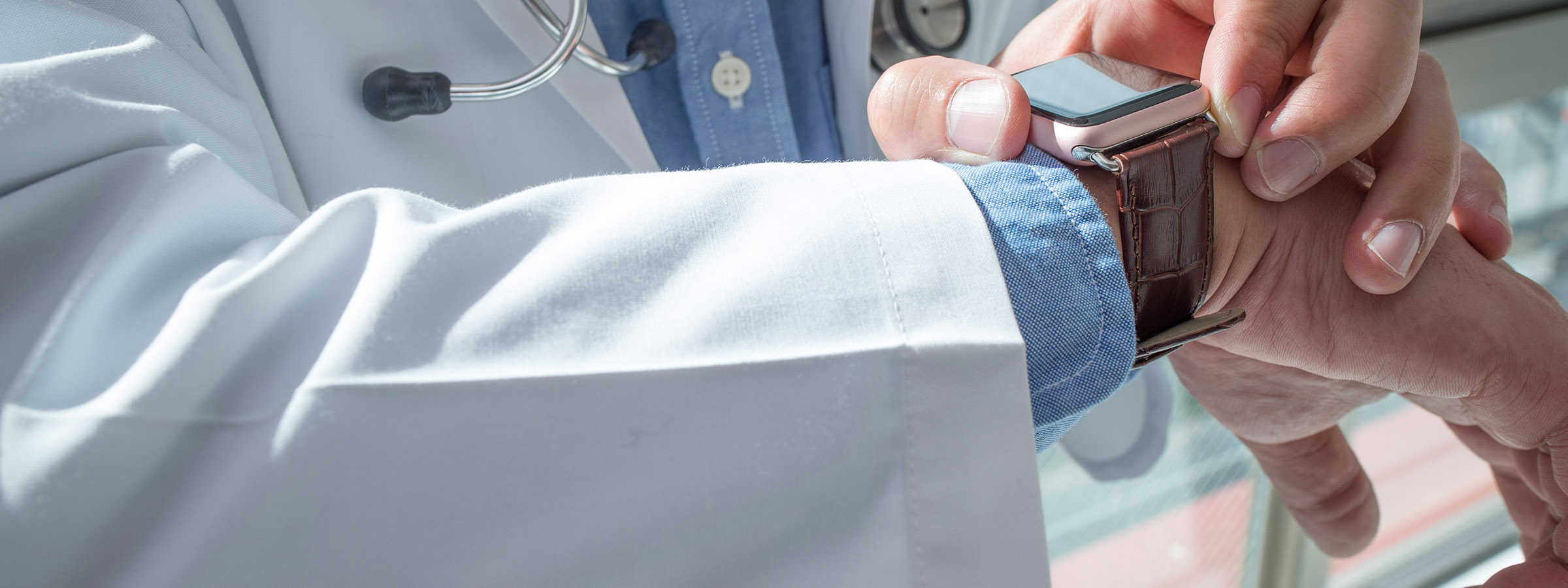 Photo of physician looking at his watch