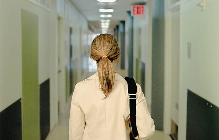 Back of a physicians head as she leaves