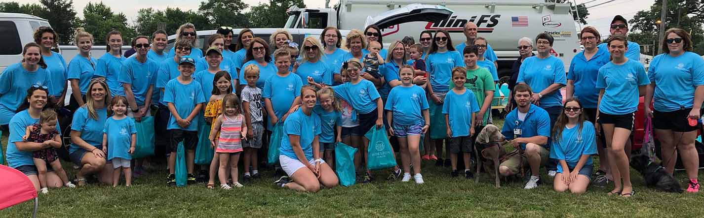 photo of a large group of people wearing blue Horizon Health t-shirts