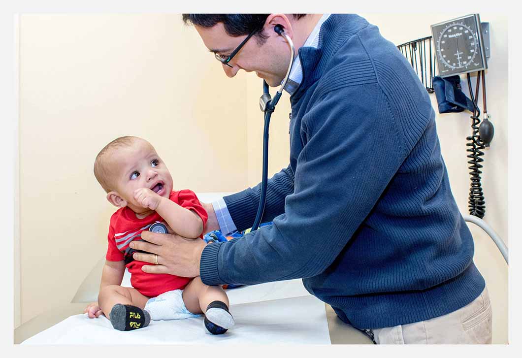 Doctor giving baby a checkup.