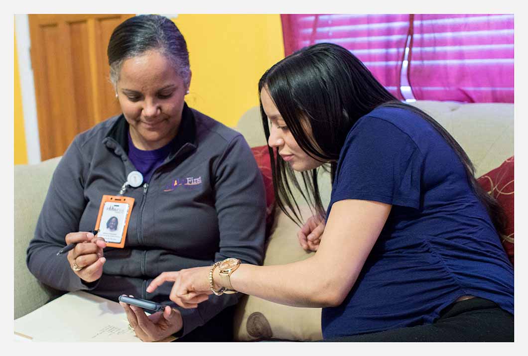 Family First worker talking to pregnant woman.