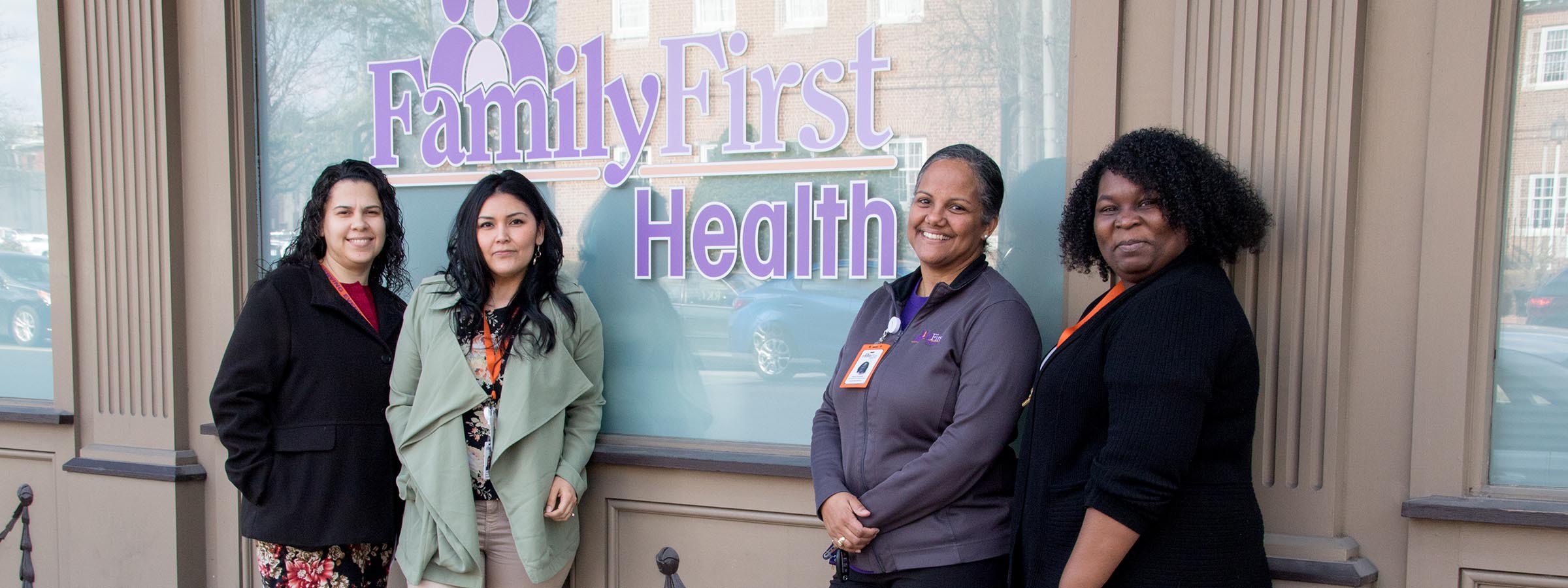 Women standing outside health clinic.