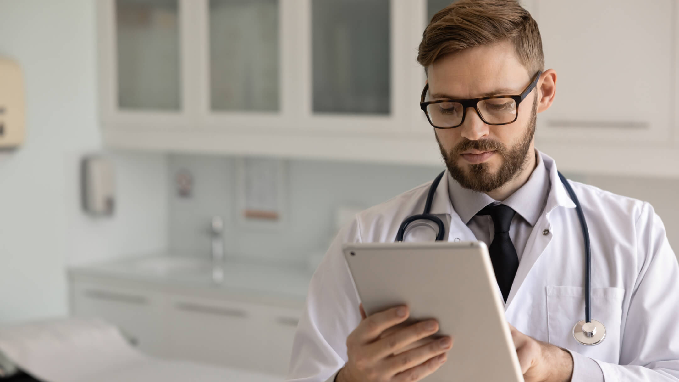 A physician interacts with a tablet, highlighting AI's impact on healthcare insights.