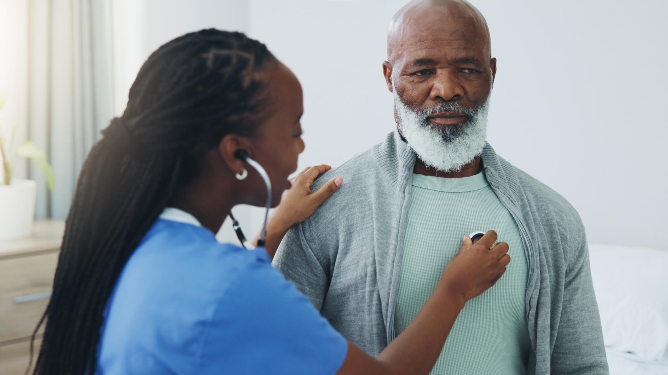 Male Medicare patient being seeing by physician