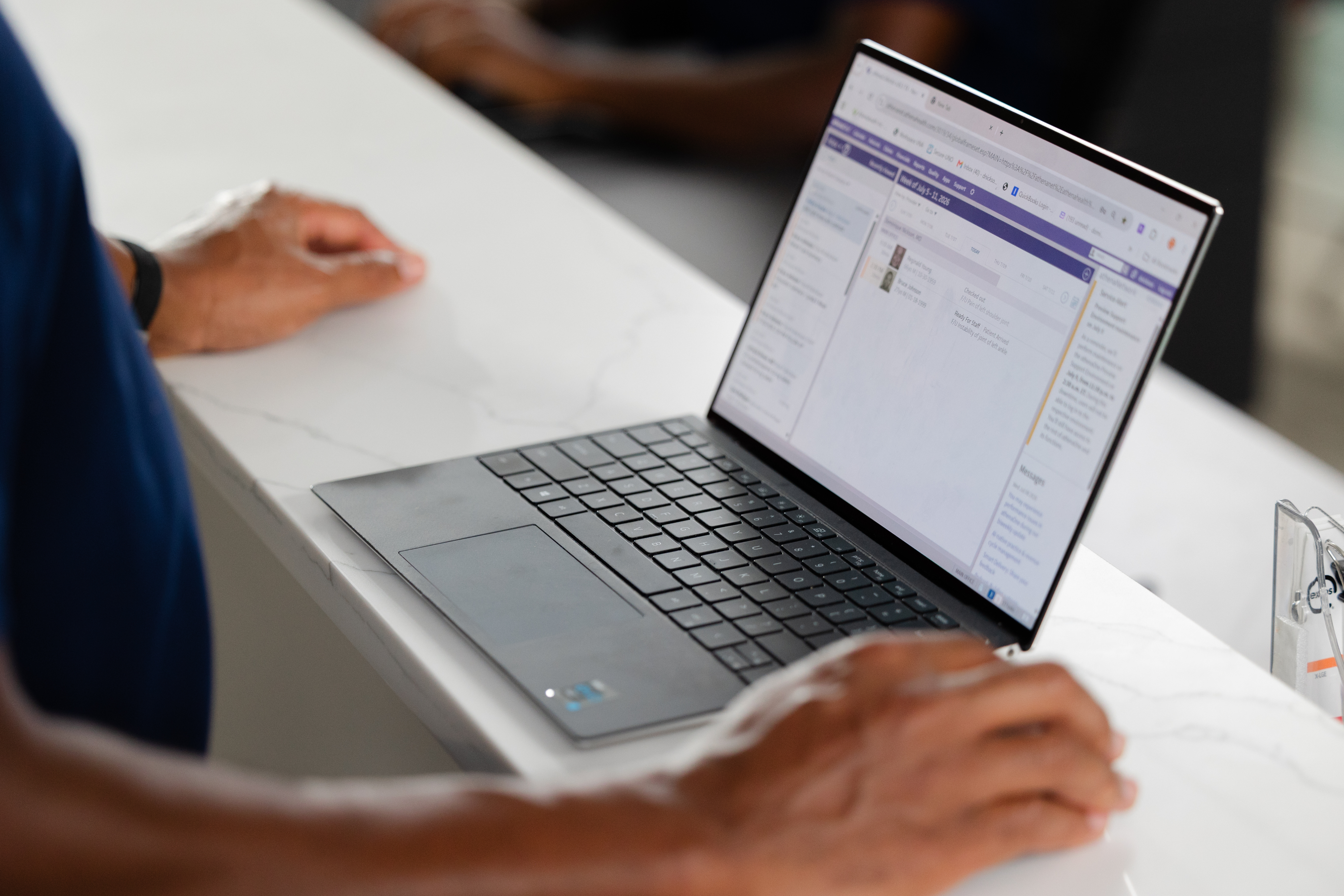 A man sitting in front of a laptop.