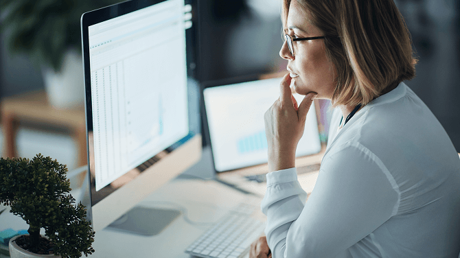 Clinician reviewing AI-powered reporting and analytics RCM insights in athenaOne.