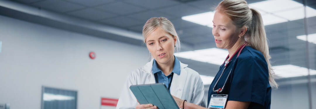 Two clinicians review the patient chart in an AI native EHR. 