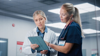 Two clinicians review the patient chart in an AI native EHR