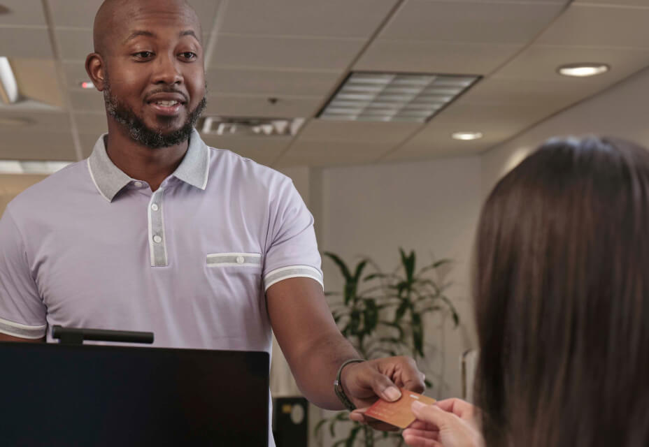 A man handing over a credit card for payment