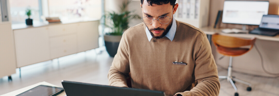 A physician working on his laptop demonstrates the importance of direct integration for payers.