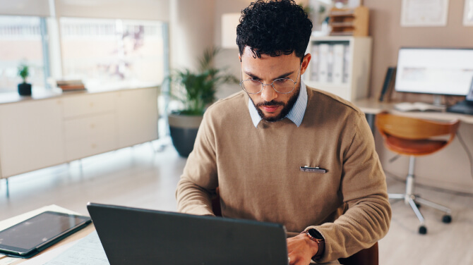 A physician working on his laptop demonstrates the importance of direct integration for payers.