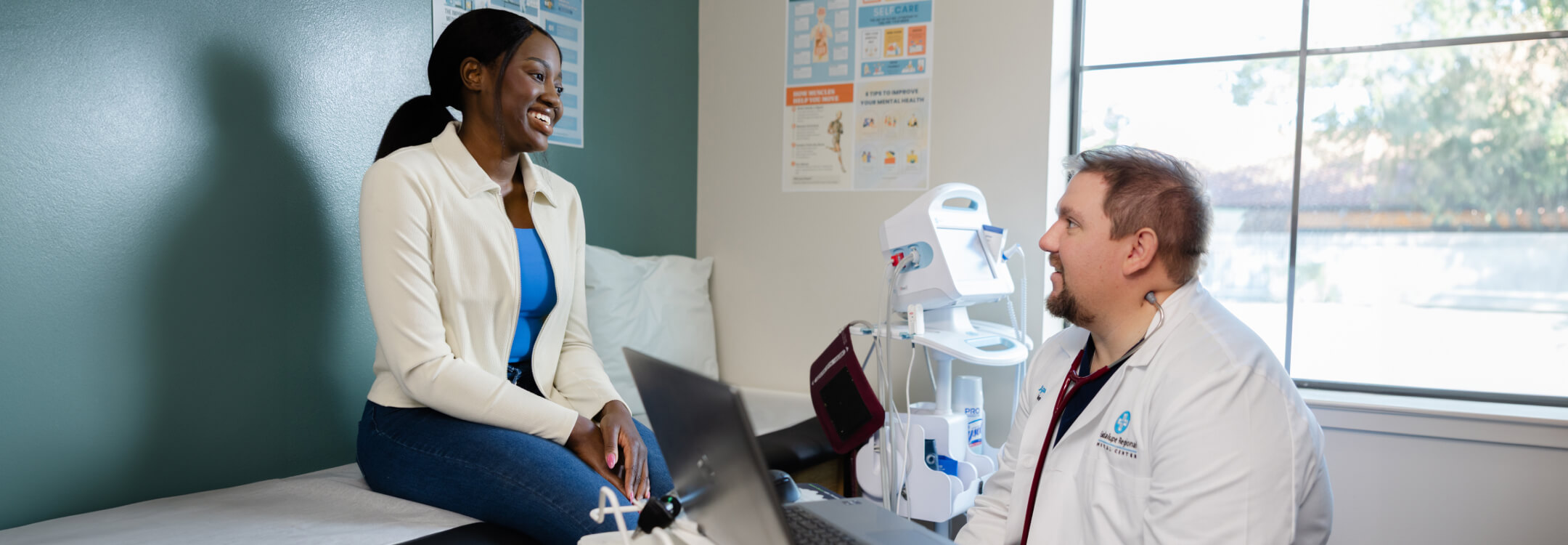 A doctor consults with a patient in a hospital room, emphasizing trust in AI healthcare over speed.