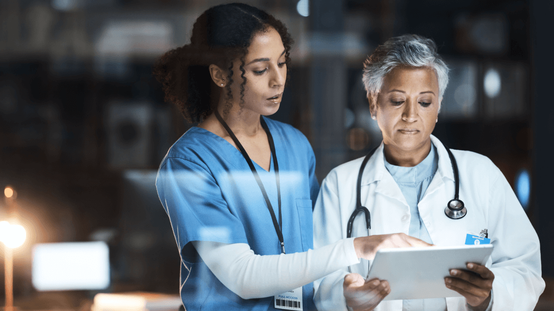 Two healthcare professionals using a tablet to access their AI-native solutions.