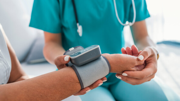 A healthcare professional checks the blood pressure of a patient, highlighting a routine medical examination.