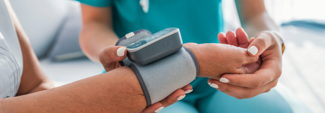 A healthcare professional checks the blood pressure of a patient, highlighting a routine medical examination.