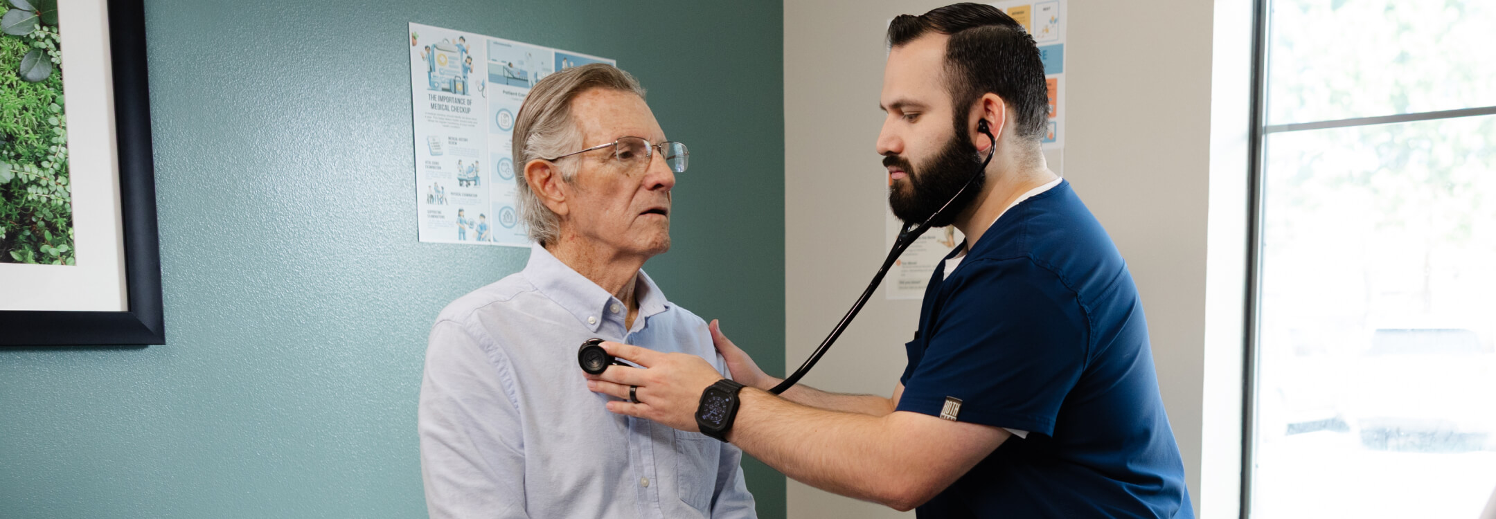 Doctor checking a patient's heart rate with a stethoscope in a clinical setting.