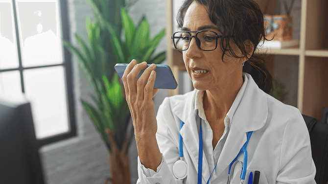 A doctor is conversing on her cell phone, focusing on generative AI best practices for clinical notes.