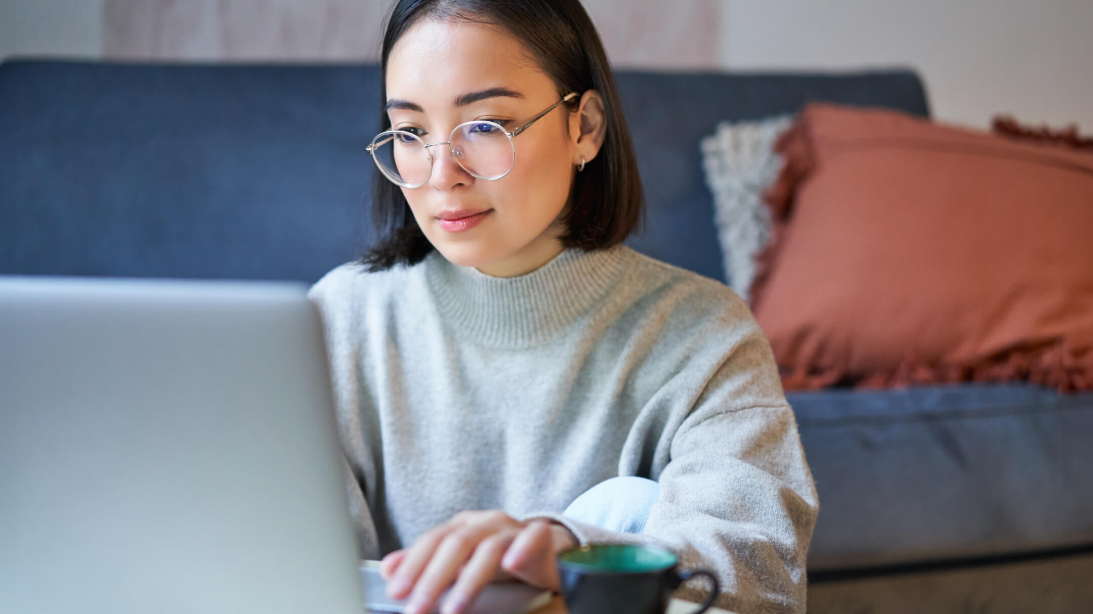  A patient sits at home, focusing on their laptop, securely accessing all of their health records in one spot.