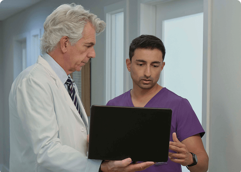 two medical staff looking at documentation on tablet