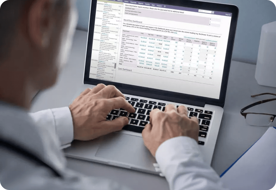 Physician on laptop following up with claims through athenaOne