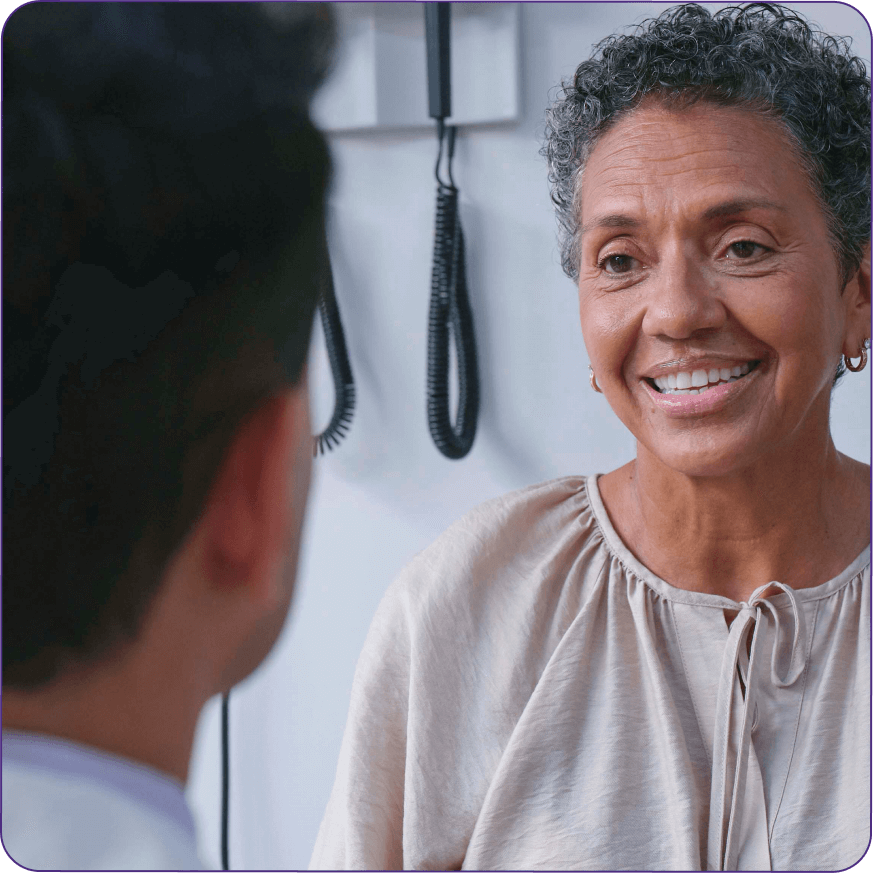 A patient engages in conversation with a doctor, addressing health concerns in a clinical environment.
