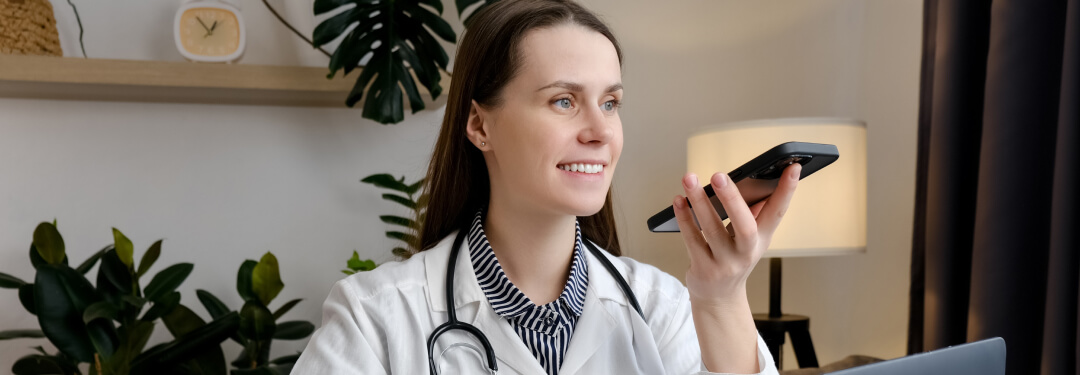 Female doctor using AI voice dictation tools for clinical documentation.
