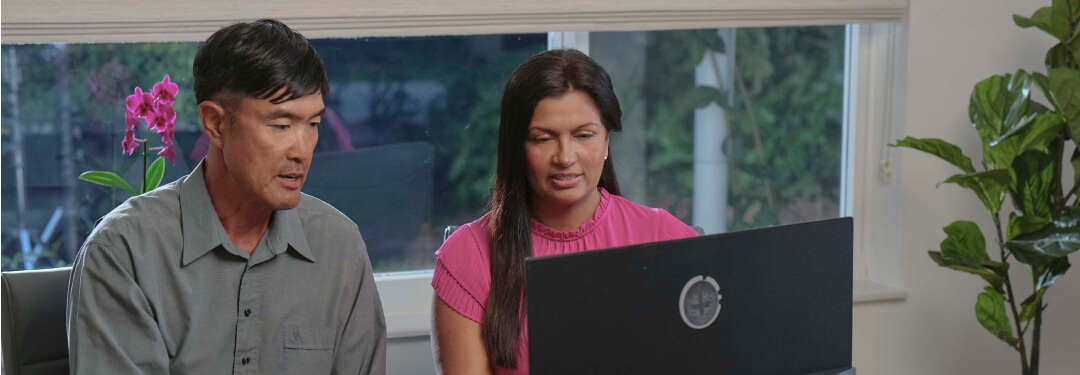 Two healthcare professionals are working together at a desk, addressing challenges in healthcare practices and technology.