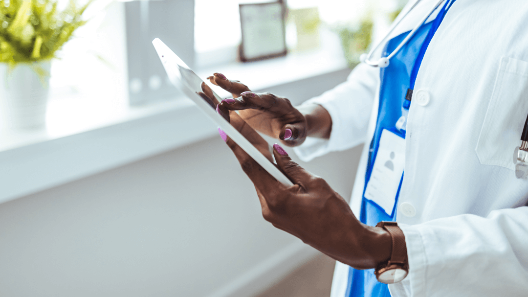A physician interacts with a tablet, utilizing medical illustration tools to improve clinical workflow efficiency.