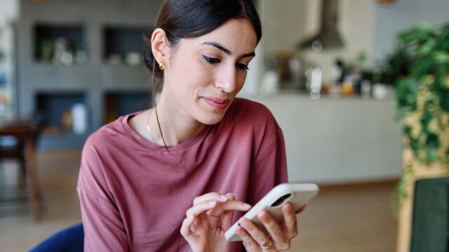 A patient is engaged with her phone, using enhanced patient engagement through NextPatient" is grammatically correct.