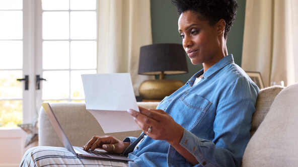 A woman at home viewing her medical records through patient portal