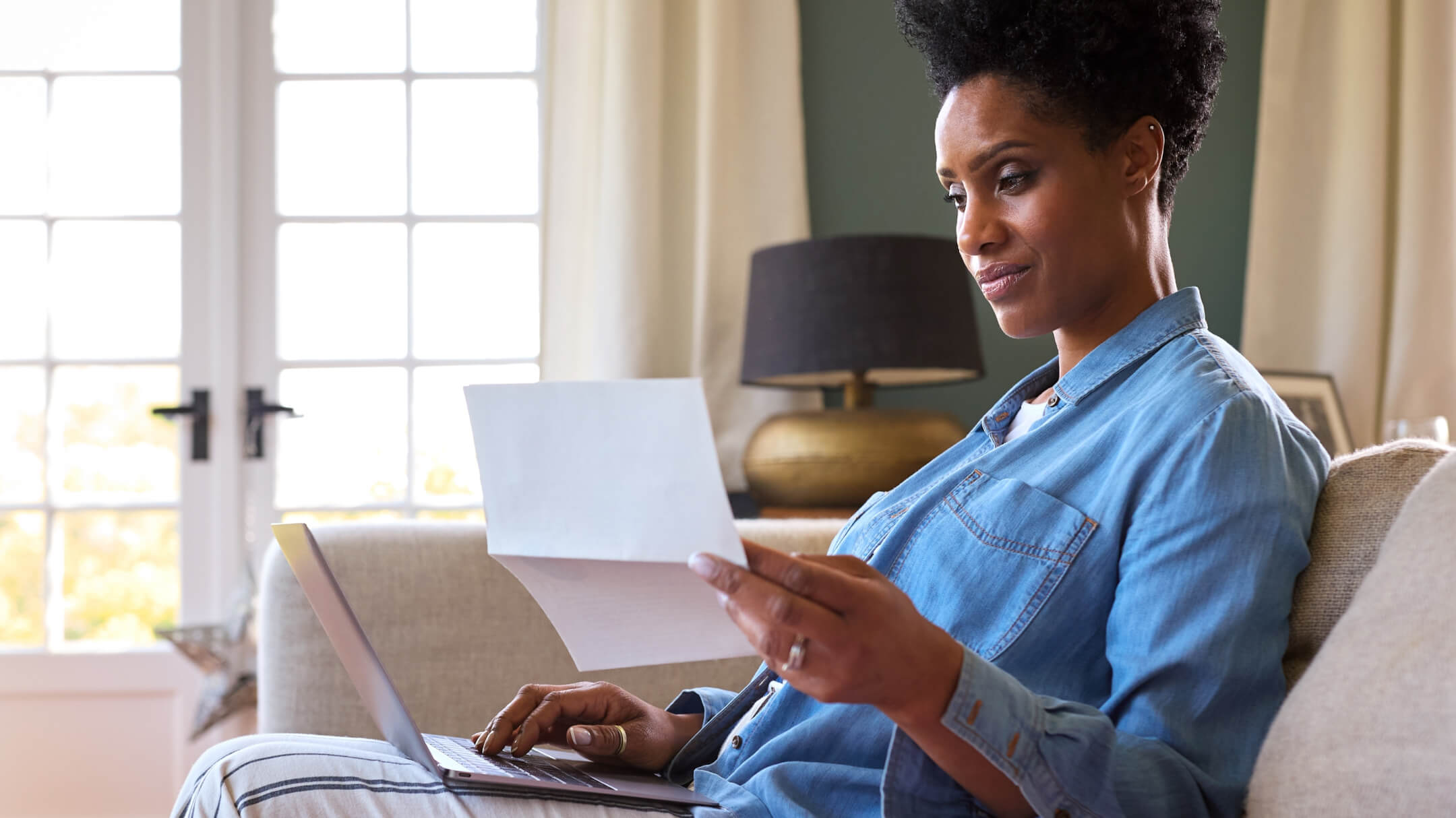 A woman at home viewing her medical records through patient portal