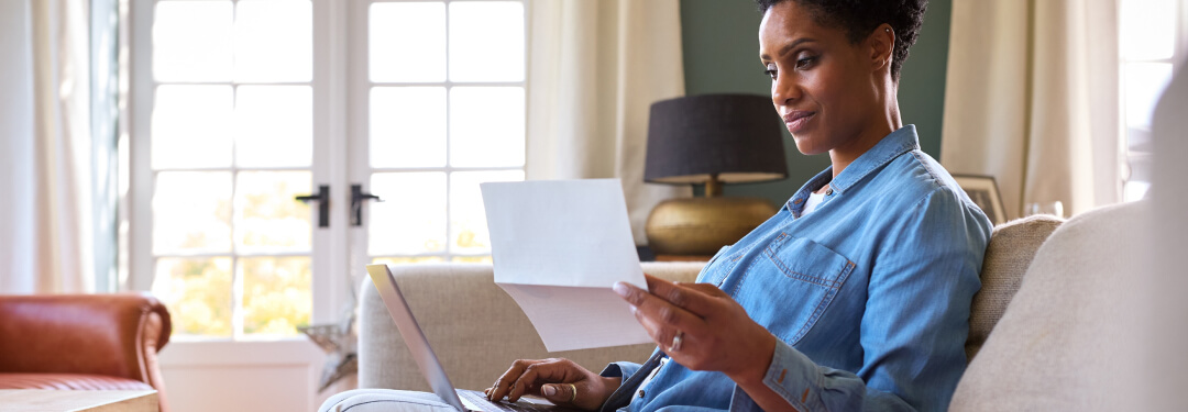 A woman at home viewing her medical records through patient portal