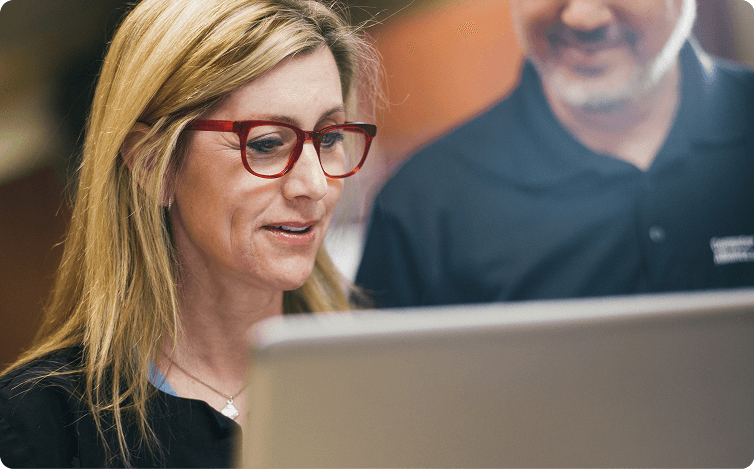 Healthcare staff with coworker looking at documentation on monitor