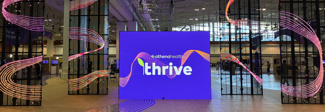 A large display with the word "Thrive," representing the athenahealth Thrive 2025 initiative focused on connection and growth.