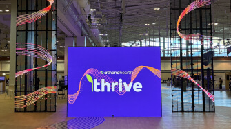 A large display with the word "Thrive," representing the athenahealth Thrive 2025 initiative focused on connection and growth.