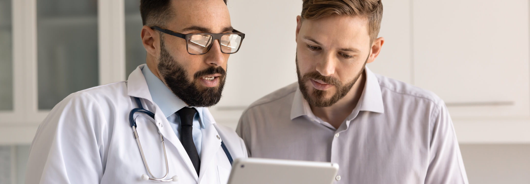 Physician using AI tools on tablet showing his patient medical records