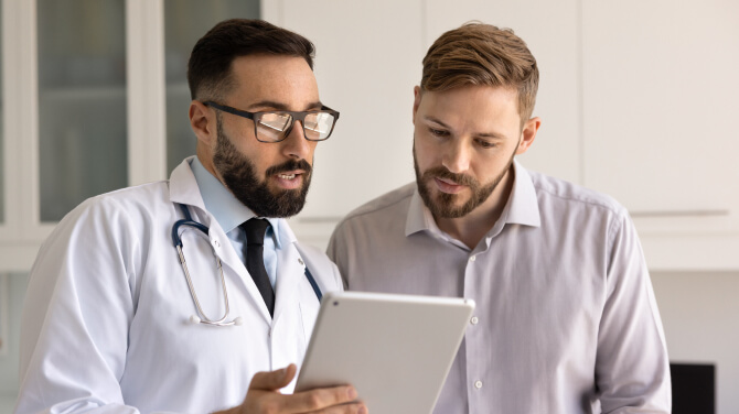 Physician using AI tools on tablet showing his patient medical records 