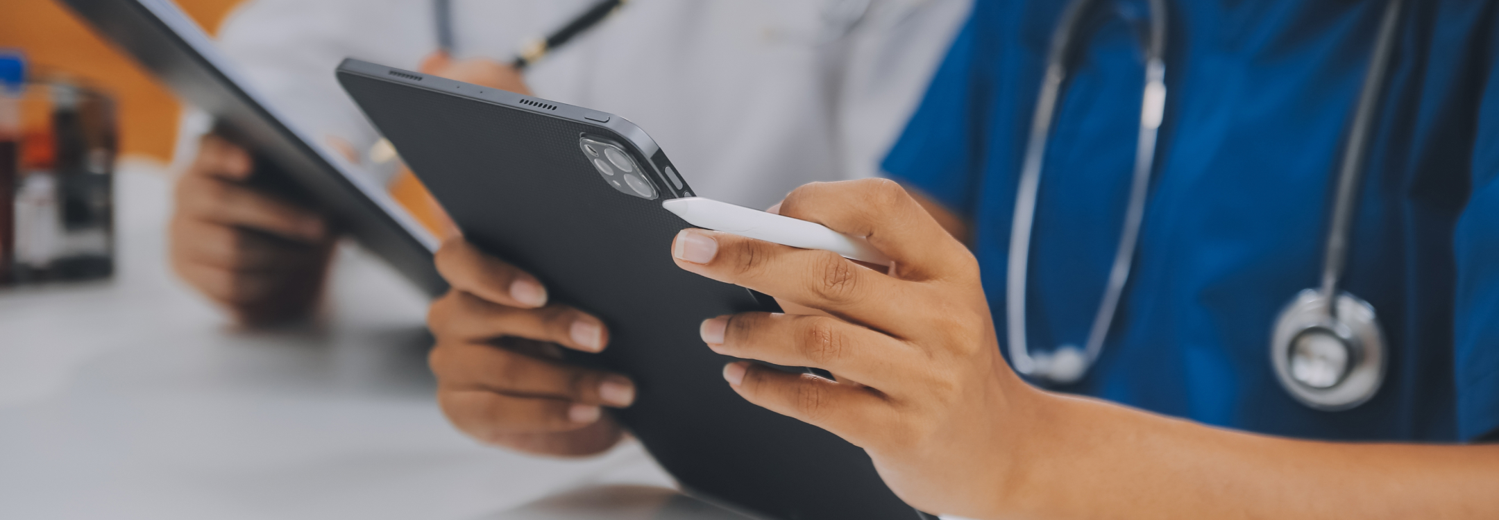Clinician checks a tablet after receiving a discharge alert through athenahealth Platform Services.