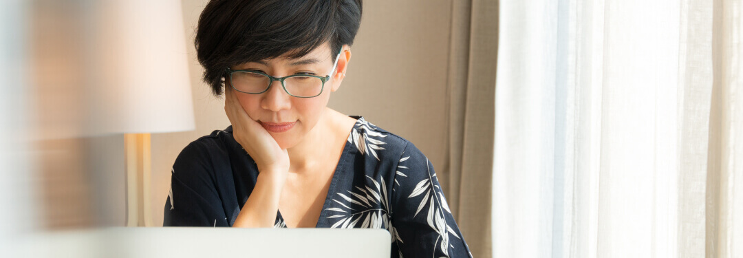 Female patient accessing her medical records on laptop at home